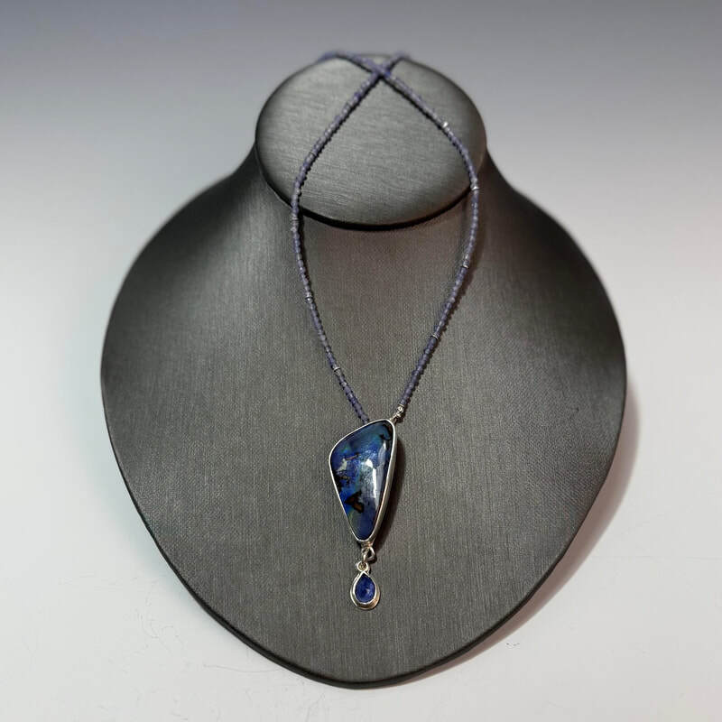 Crescent Moon Nebula.
Boulder opal and rose cut tanzanite beaded necklace. Sterling and fine silvers. 21
