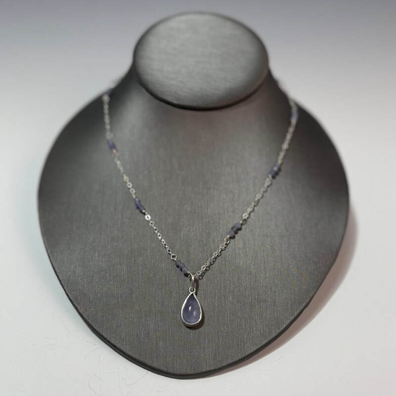 Holley blue chalcedony set in fine and sterling silvers. Sterling chain with tanzanite beaded accents. 26