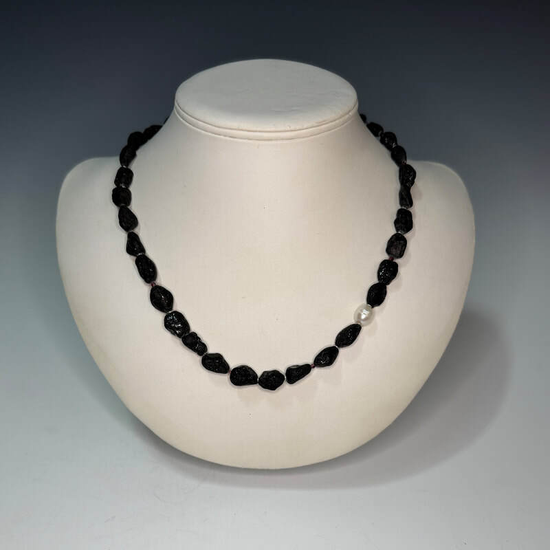 River tumbled black tourmaline pebbles with 10x8mm cultured pearl accent. 2mm garnet beaded necklace with sterling silver clasp. 19